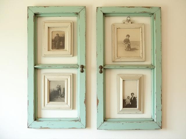 Old wooden window frames repurposed into a decorative wall collage with mirrors and small photos.