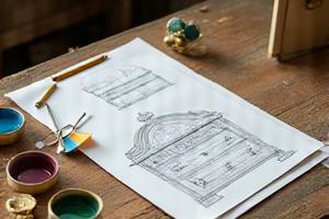 Sketches and color swatches on a vintage furniture piece, illustrating 'The Vision' for its transformation.